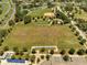 Aerial shot features an athletic field with baseball diamond, tennis courts, and well-maintained surroundings at 42 Chip Ct, Kissimmee, FL 34759