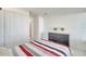 A well-lit bedroom boasts neutral walls, tile flooring, a closet, and a dark dresser at 42 Chip Ct, Kissimmee, FL 34759