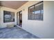 Covered patio features two windows, a sliding glass door, and a small storage bench at 42 Chip Ct, Kissimmee, FL 34759