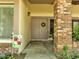 Welcoming front entry features double doors, brick columns, and decorative plants at 42 Chip Ct, Kissimmee, FL 34759