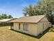 Back of the home with an enclosed patio and a fenced in backyard at 42 Chip Ct, Kissimmee, FL 34759