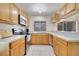 Functional kitchen with modern appliances and wood cabinetry at 42 Chip Ct, Kissimmee, FL 34759
