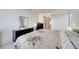 A well-lit main bedroom boasts neutral walls, tile flooring, a closet, and a dark dresser at 42 Chip Ct, Kissimmee, FL 34759