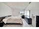 A bright main bedroom features a large window, tile flooring, and neutral walls and a dark dresser at 42 Chip Ct, Kissimmee, FL 34759