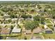 Aerial view of a neighborhood with mature trees and well maintained lawns at 42 Chip Ct, Kissimmee, FL 34759