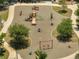 Overhead view of a neighborhood playground featuring swings, slides, and various play structures on a soft surface at 42 Chip Ct, Kissimmee, FL 34759