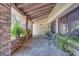 Spacious covered porch with brick columns, offering an inviting outdoor seating area at 42 Chip Ct, Kissimmee, FL 34759