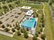 Aerial showcases community pool, clubhouse, parking lot, and surrounding green spaces, perfect for Gathering fun at 42 Chip Ct, Kissimmee, FL 34759