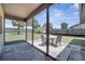 Screened in patio with an outdoor table and chairs with a view of the fenced backyard at 42 Chip Ct, Kissimmee, FL 34759