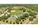 Aerial view of a community sports complex with baseball, tennis, and basketball courts surrounded by lush greenery at 42 Chip Ct, Kissimmee, FL 34759