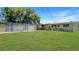 A home with multiple garages on a large lot, boasting a spacious grassy backyard at 4218 Drexel Ave, Orlando, FL 32808