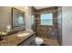 Updated bathroom featuring gray tile shower, granite countertop, and decorative accents at 4218 Drexel Ave, Orlando, FL 32808