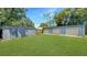 Backyard features several garages and a large lawn at 4218 Drexel Ave, Orlando, FL 32808
