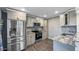 Modern kitchen featuring gray cabinets, stainless steel appliances, and granite countertops at 4218 Drexel Ave, Orlando, FL 32808