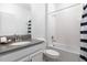 Bright bathroom features a single vanity, a clean white bathtub and neutral tones for a modern feel at 4290 Paragraph Dr, Kissimmee, FL 34746