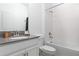 Bright, clean bathroom featuring a tub with shower and sleek fixtures, perfect for a modern home at 4290 Paragraph Dr, Kissimmee, FL 34746