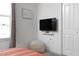 Bedroom offering a cozy nook with a soft pouf and a wall-mounted TV for relaxation and comfort at 4290 Paragraph Dr, Kissimmee, FL 34746