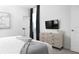 Bright bedroom featuring neutral decor, a dresser, and a wall-mounted television for relaxing and entertaining at 4290 Paragraph Dr, Kissimmee, FL 34746
