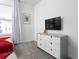 Bedroom with a TV and a dresser offering storage and entertainment space, great for relaxation at 4290 Paragraph Dr, Kissimmee, FL 34746