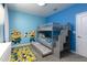 bedroom featuring a bunk bed, minion wall decals, and blue walls at 4290 Paragraph Dr, Kissimmee, FL 34746