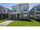 Modern two-story home with a well-maintained lawn and a two-car garage at 4290 Paragraph Dr, Kissimmee, FL 34746