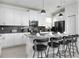 Stylish kitchen featuring sleek white cabinets, a dark backsplash, and bar stool seating at 4290 Paragraph Dr, Kissimmee, FL 34746