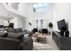 Bright and airy living room showcasing a large sofa, modern furniture, and high ceilings at 4290 Paragraph Dr, Kissimmee, FL 34746