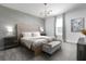 Beautiful bedroom with decorative wall, tufted headboard, and modern lighting fixture at 4290 Paragraph Dr, Kissimmee, FL 34746