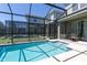 Enclosed pool and jacuzzi with table and chairs, perfect for relaxation at 4290 Paragraph Dr, Kissimmee, FL 34746