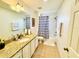Bathroom with granite vanity top, large mirror, and decorative shower curtain at 467 Martigues Drive, Kissimmee, FL 34759