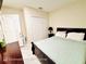 Bedroom with a large closet, tiled floors and a queen sized bed at 467 Martigues Drive, Kissimmee, FL 34759