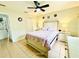 Bedroom with tiled floors, ceiling fan, and cozy bed with floral patterned bedding at 467 Martigues Drive, Kissimmee, FL 34759