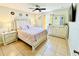 Bright bedroom featuring tiled floors, ceiling fan, and a comfortable-looking bed at 467 Martigues Drive, Kissimmee, FL 34759