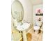 Clean and tidy half bathroom with a pedestal sink, round mirror, and tiled flooring at 467 Martigues Drive, Kissimmee, FL 34759