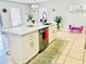 Bright kitchen island featuring stainless steel appliances, white cabinets, and a stylish countertop at 467 Martigues Drive, Kissimmee, FL 34759