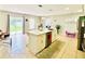 Bright kitchen island featuring stainless steel appliances, white cabinets, and a stylish countertop at 467 Martigues Drive, Kissimmee, FL 34759