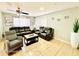 Comfortable living room with leather seating, ceiling fan, and bright window for natural light at 467 Martigues Drive, Kissimmee, FL 34759