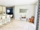 Open living space with kitchen island and dining area, enhanced by natural light and neutral tones at 467 Martigues Drive, Kissimmee, FL 34759