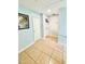 Upstairs hallway with light blue walls, tile flooring, and white doors to various rooms at 467 Martigues Drive, Kissimmee, FL 34759