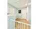 Bright upstairs hallway with tile flooring, white doors, and a secure baby gate at 467 Martigues Drive, Kissimmee, FL 34759