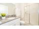 Bright bathroom with gray countertops, a glass-enclosed shower, and modern fixtures at 4832 Dedication St, Kissimmee, FL 34746