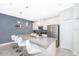 Modern kitchen island with sleek countertops, bar seating, and stainless steel appliances at 4832 Dedication St, Kissimmee, FL 34746