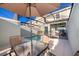 Relaxing outdoor patio seating near a screened-in pool, great for leisure at 4832 Dedication St, Kissimmee, FL 34746