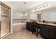 A luxurious bathroom featuring a walk-in shower, garden tub, granite countertop, and dual sinks at 501 Pheasant Dr, Haines City, FL 33844