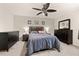 Spacious carpeted bedroom features a ceiling fan, dark wood furniture, and a comfortable-looking bed at 501 Pheasant Dr, Haines City, FL 33844