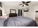 Bedroom with ceiling fan, tv, large dresser, and closet at 501 Pheasant Dr, Haines City, FL 33844