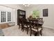 Elegant dining room featuring neutral carpet, a modern chandelier, and an airy atmosphere at 501 Pheasant Dr, Haines City, FL 33844