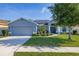 Charming one-story home with manicured landscaping and a gray exterior at 501 Pheasant Dr, Haines City, FL 33844