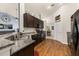Well-equipped kitchen featuring dark wood cabinets, granite countertops and stainless steel appliances at 501 Pheasant Dr, Haines City, FL 33844