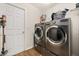 Functional laundry room with stainless steel washer and dryer set at 501 Pheasant Dr, Haines City, FL 33844